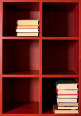 Books on a brown shelf