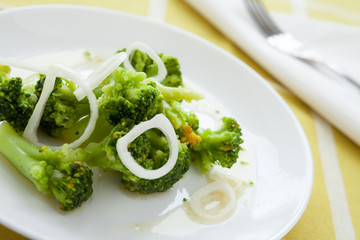 baked broccoli on a white dish