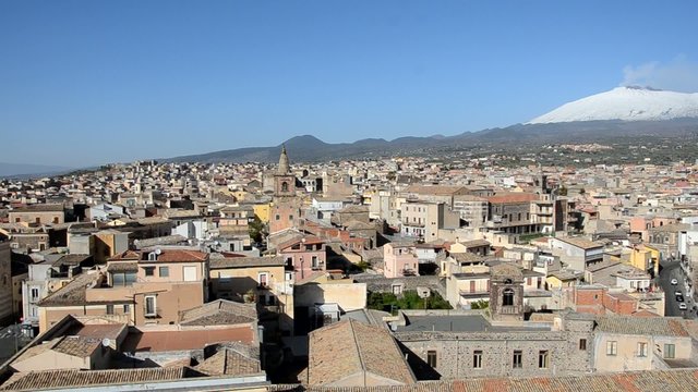 Panoramic view of sicilian town and Etna volcano