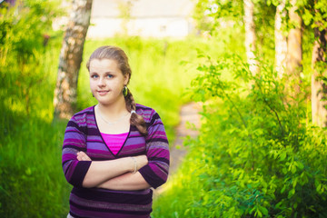 Fototapeta premium A Beautiful Young Girl Standing On A Forest Path Road