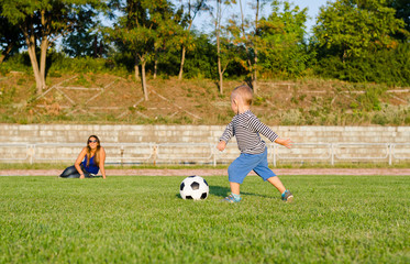 Athletic small boy playing soccer