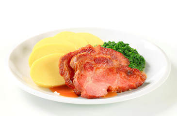 Smoked pork neck with potato dumplings and spinach