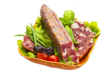 Ripe salami with salad, basil, onion and tomato