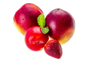 Ripe bright peaches, plum, strawberry and mint