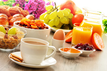 Breakfast including coffee, bread, honey, orange juice, muesli a