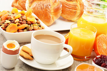 Breakfast including coffee, bread, honey, orange juice, muesli a