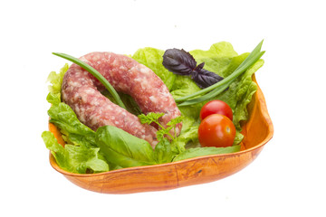 Ripe salami with salad, basil, onion and tomato