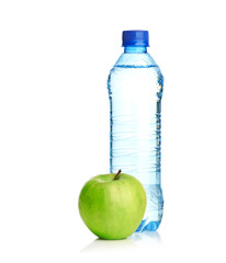 Bottle of sparkling water and green apple