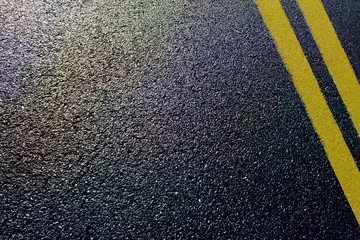 asphalt detail with yellow double line - obrazy, fototapety, plakaty