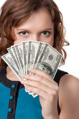 Portrait of pretty young woman holding a fan of dollar bills