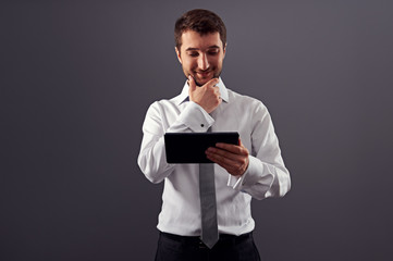 businessman looking at tablet pc and smiling