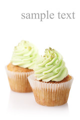two cupcakes with green cream isolated on white background with