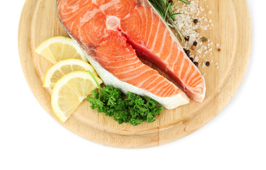 Fresh salmon steak on cutting board, isolated on white