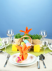Easter table setting on color background