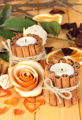 Decorative rose from dry orange peel and burning candles