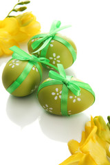 Bright easter eggs with bow and flowers, isolated on white