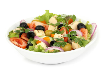Greek salad in plate isolated on white