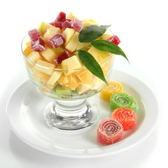 Fruit salad in a sundae dish isolated on white