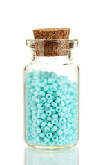 Little bottle full with colorful beads isolated on white