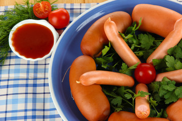 Sausage, greens, tomato on plate