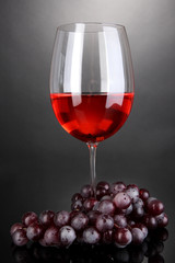 Red wine glass on grey background