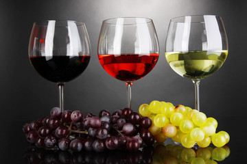 Assortment of wine in glasses on grey background