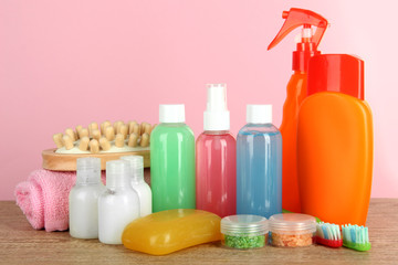 Hotel amenities kit on table on pink background