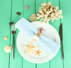 Marine table setting on color wooden background
