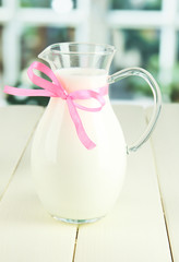 Pitcher of milk on table in room
