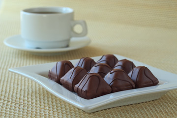 Cup of coffee and chocolate candies