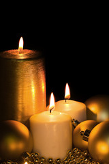 Golden Christmas Candle on the black
