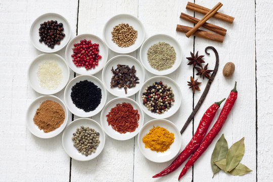 Spices and dried vegetables on vintage white planks