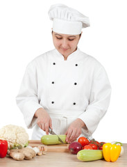 Woman chef chops vegetables for cooking