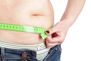 Fat woman sewing meter measures the waist abdomen. On a white ba