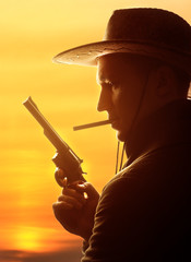 cowboy in hat with cigar and revolver