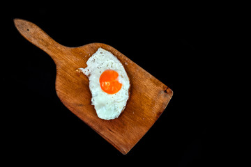fried egg isolated on black background