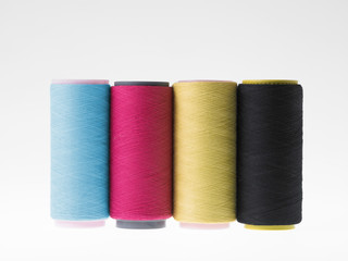 Colors, spools of thread on a white background