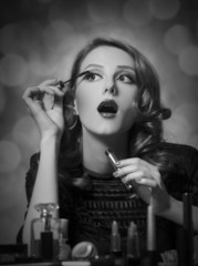 Woman applying cosmetics