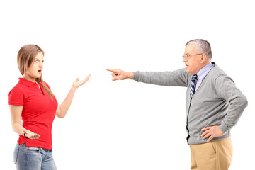 Angry father pointing at his daughter