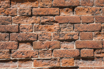 Old weathered red brick wall as background
