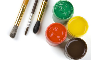 Paints and brushes over white background with space for text