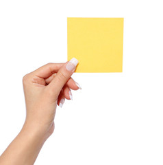 female hand holding note paper, isolated, yellow sticker