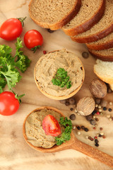 Fresh pate on wooden spoon, on wooden background