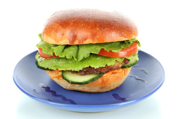 Big and tasty hamburger on plate isolated on white