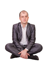 A man sits cross-legged