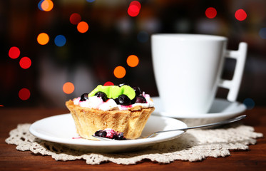 Tasty blackberry cake and cup of beverage,
