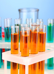 Laboratory pipette with drop of color liquid over glass test