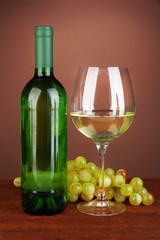 Fototapeta premium Composition of wine bottle, glass of white wine, grape