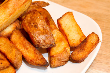 Oven baked potato chips on a white plate