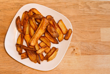 Oven baked potato chips on a white plate